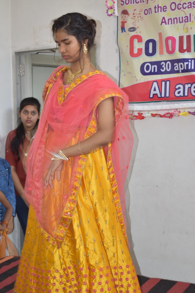Young girl dressed in traditional saree posing confidently for a photo during the school's foundation ceremony