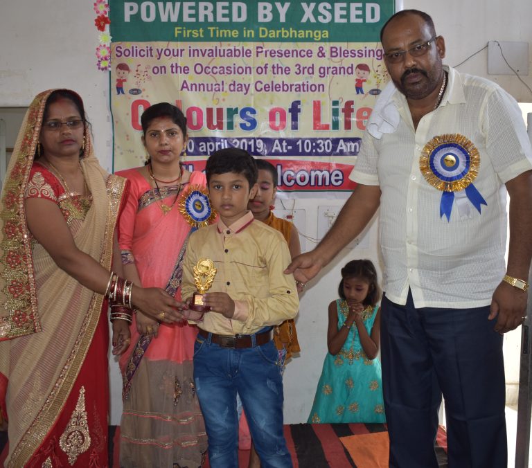 Director Mam presenting an award to a student during the foundation ceremony