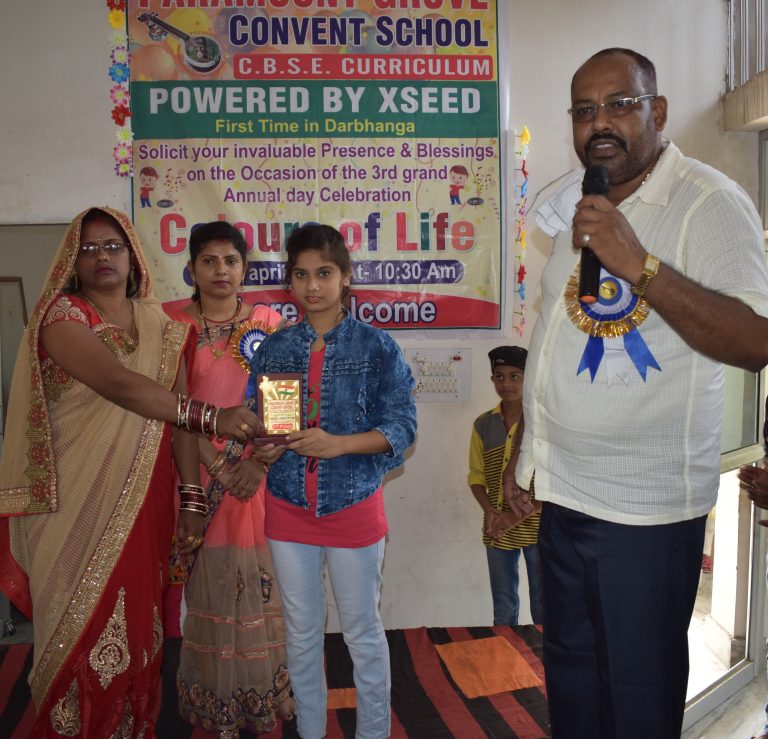 Principal awarding student during prize ceremony