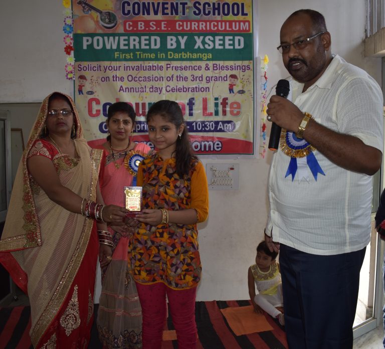 Director Mam presenting an award to a student during the foundation ceremony