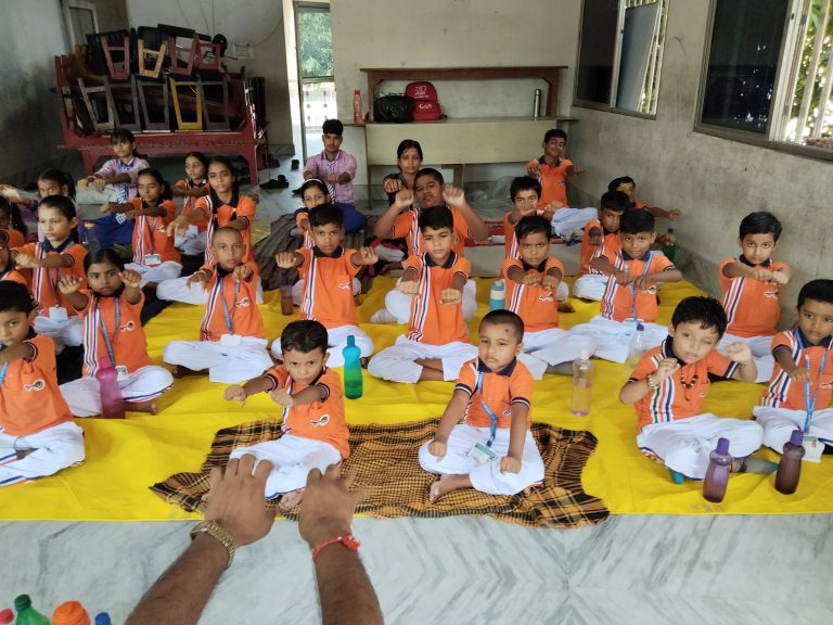 Students practicing yoga in school ground